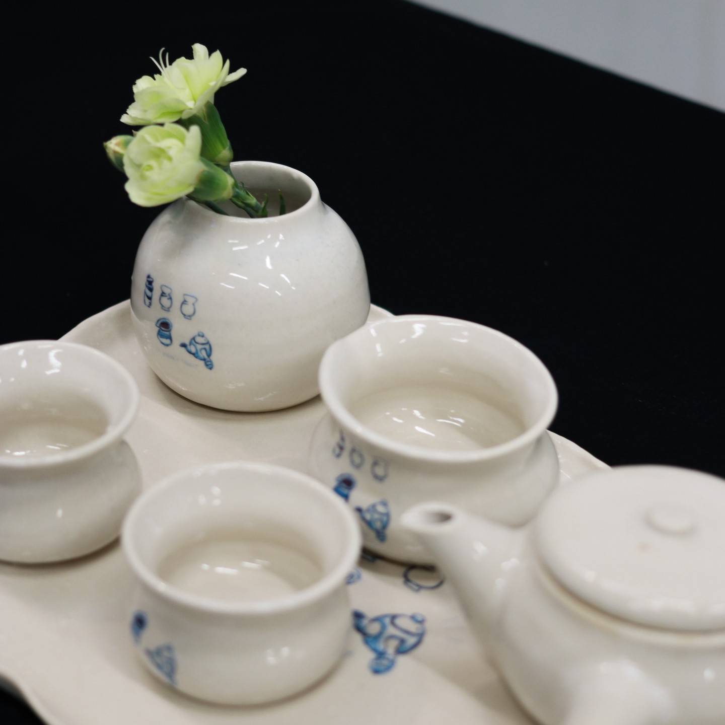 A collection of handmade ceramic plates and dishes, each with a unique design