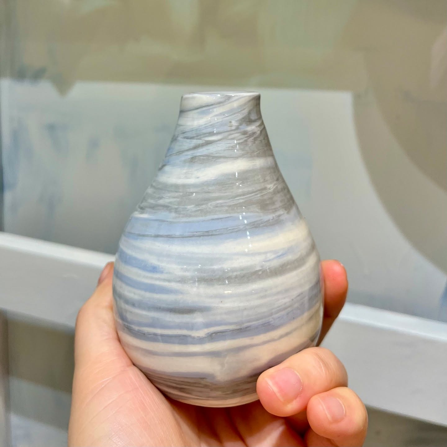 Handmade mini ceramic vase with a marbled gray and white pattern